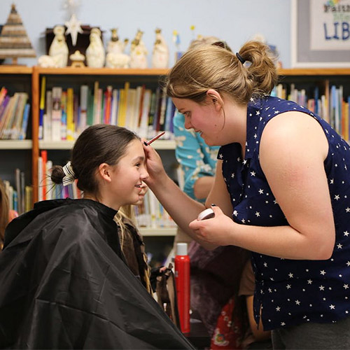 Instructor painting a student's face