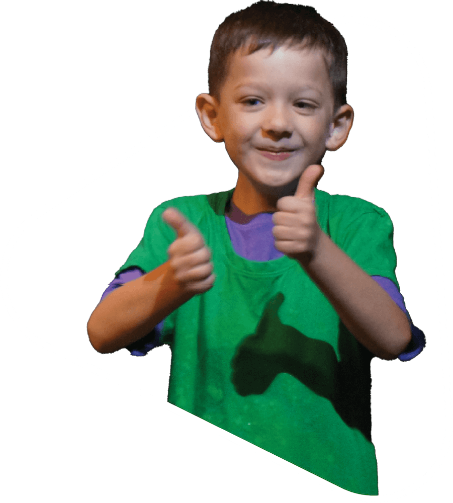 Younger boy posing with thumbs up